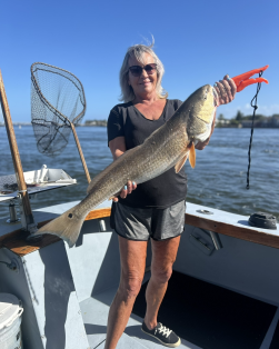 Woman holding large redfish from a Charter in St. Augustine, Fl