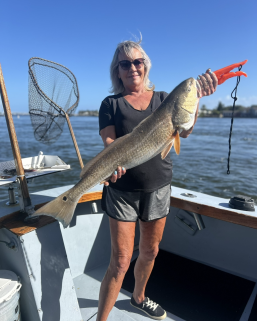 Fishing Charters 15 Woman holding large redfish from a Charter in St. Augustine, Fl